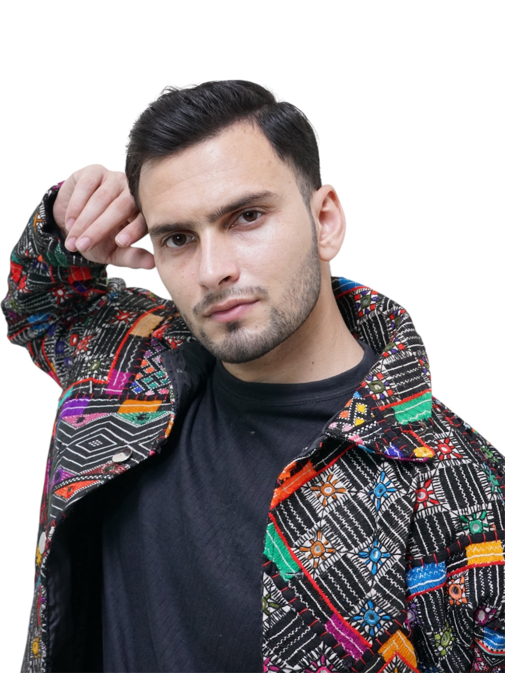 Man wearing a colorful patterned jacket on a white background