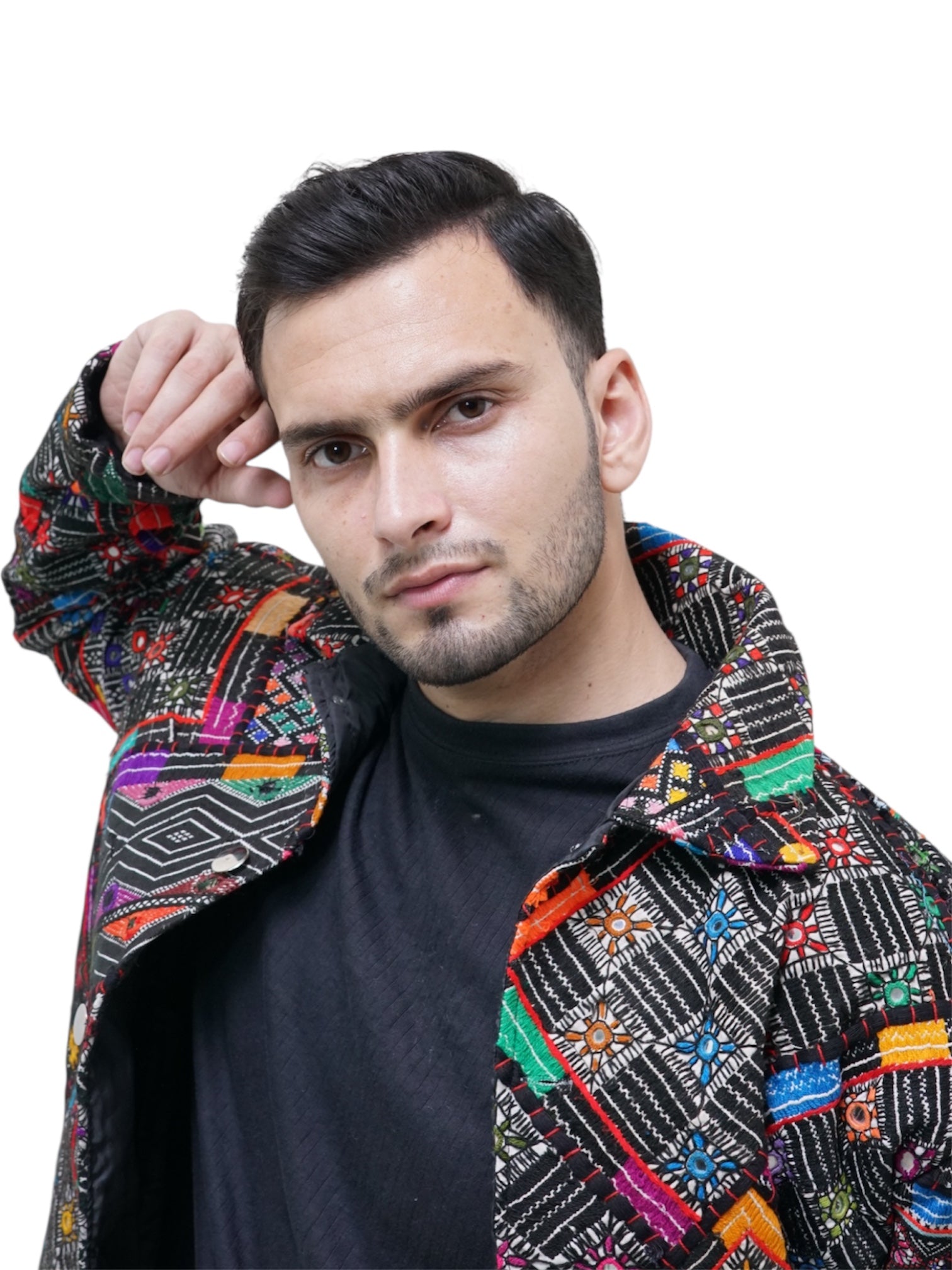 Man wearing a colorful patterned jacket on a white background