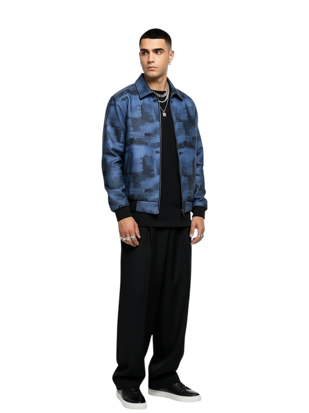 Man wearing a blue camouflage jacket and black pants on a white background