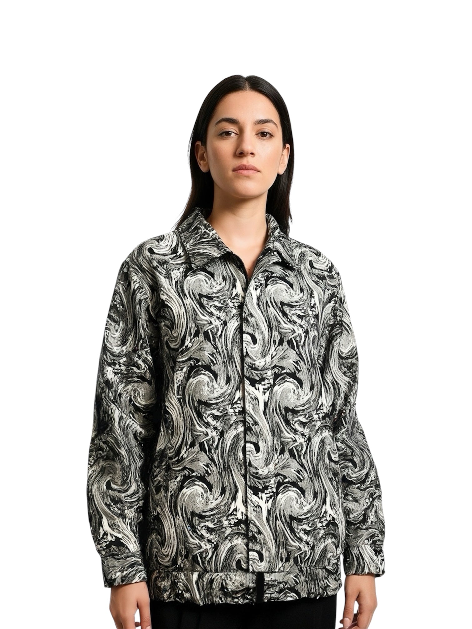 Woman wearing a black and white patterned shirt on a white background